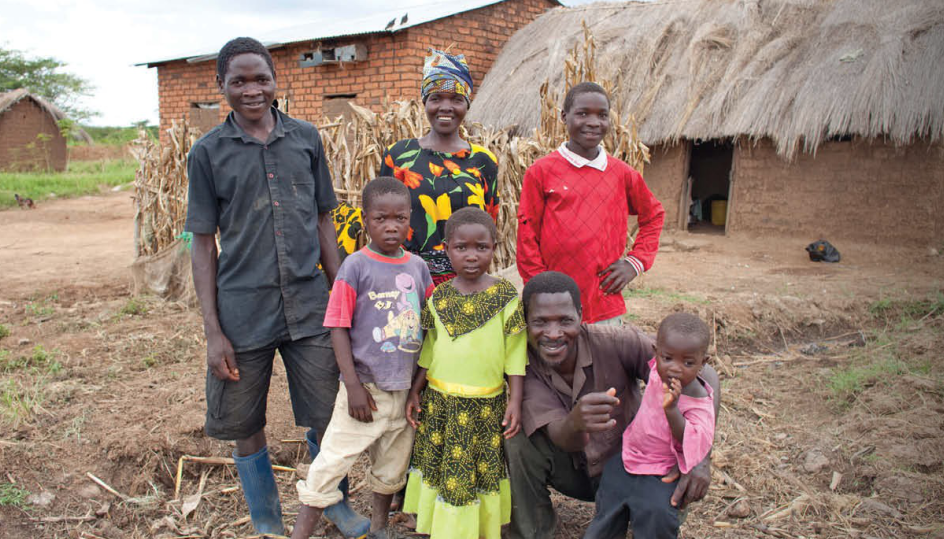 Heifer International aquculture project participant Nicholas Mwakabelele and his family in Tanzania