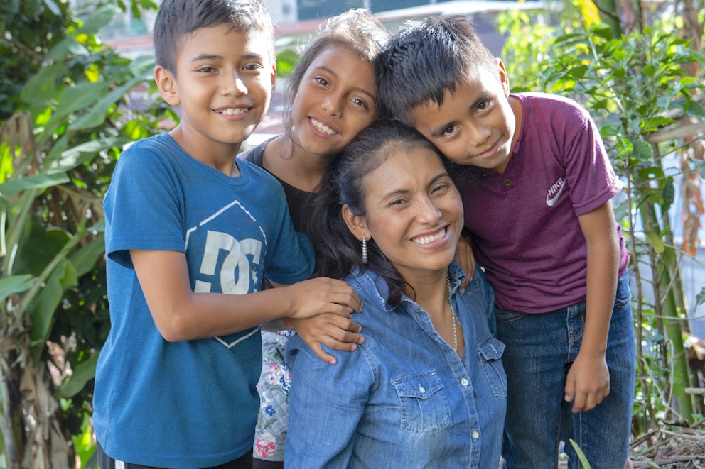 Brenda Reyes and family smile at the camera