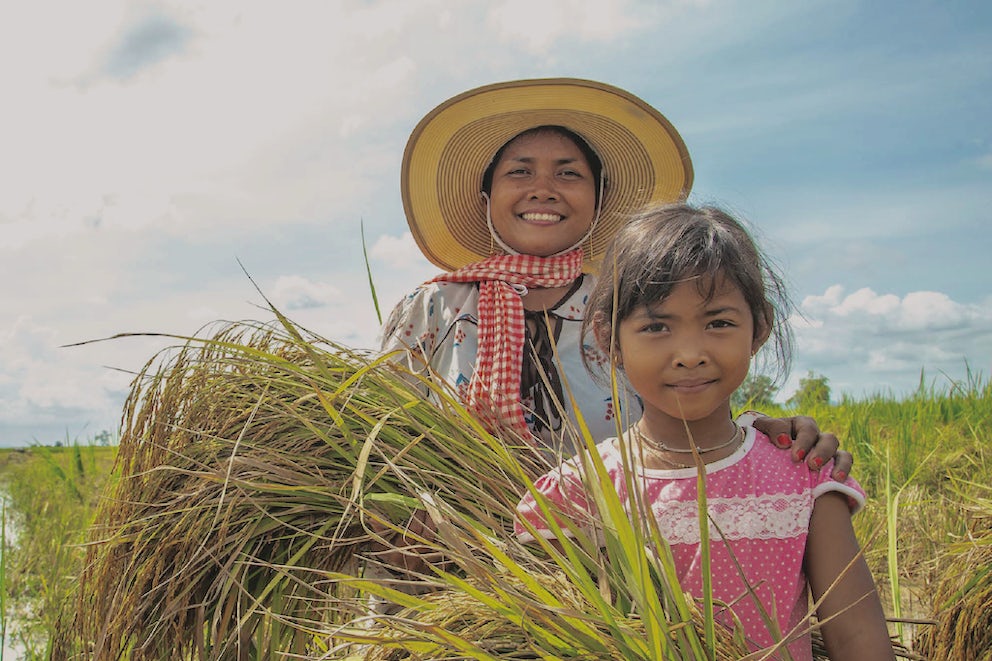 A mother and daughter stand in their field