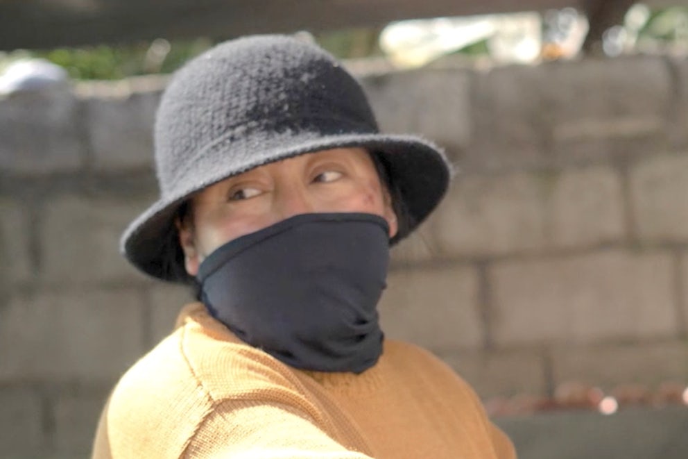 Farmer with mask prepares food