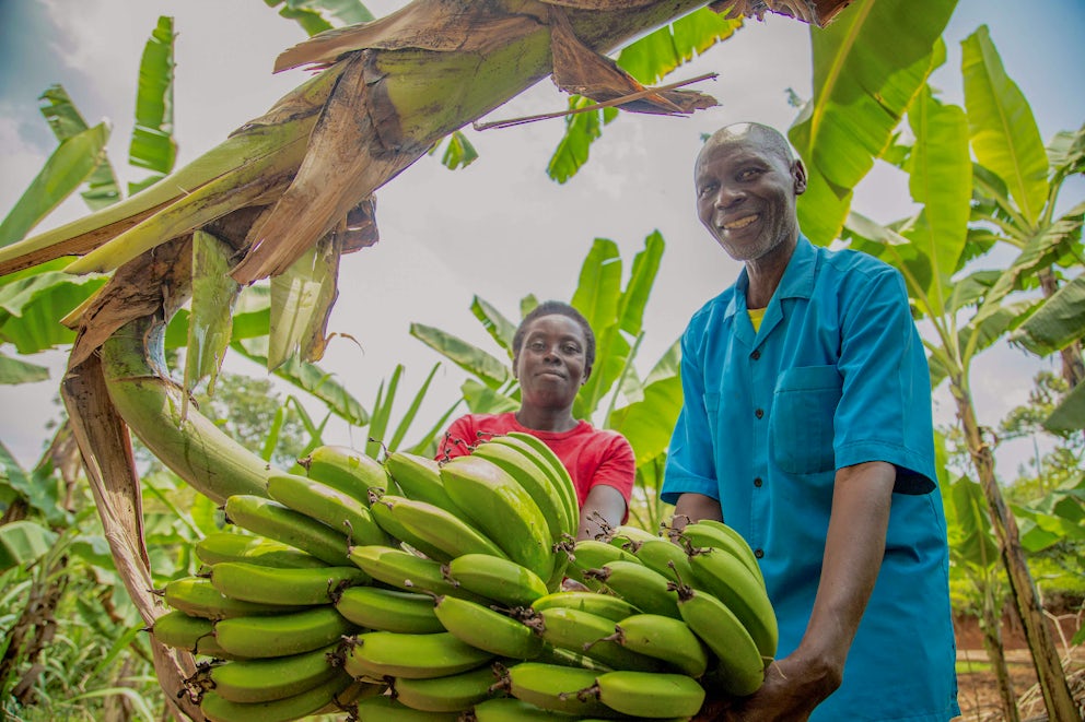 Man and woman holding bananas