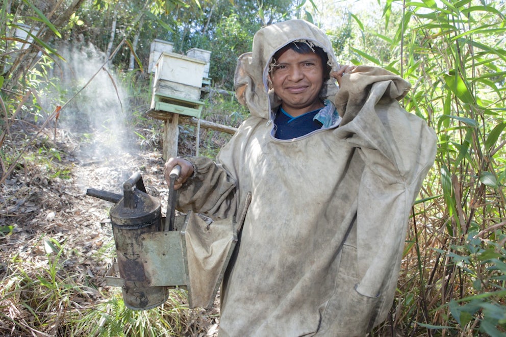 Leonids Lemos, 35, prepares to work on his beehives in Piedra Rayada village, Honduras.