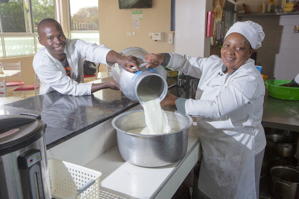 Dairy farmer Michael Njagi Ndwiga is shown pouring milk in Kenya
