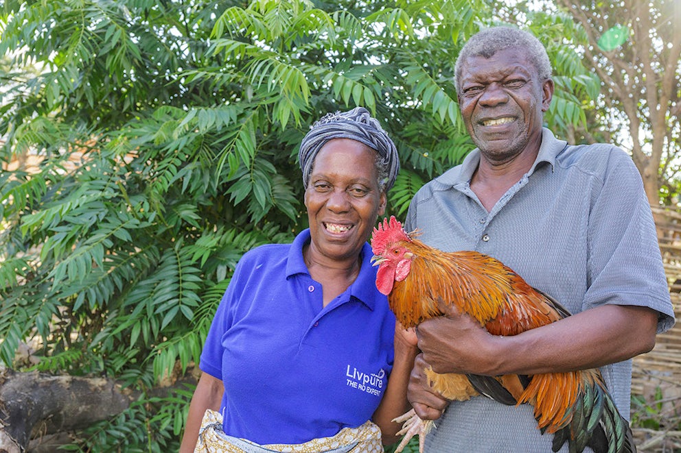 Farmers from Zambia holding chicken