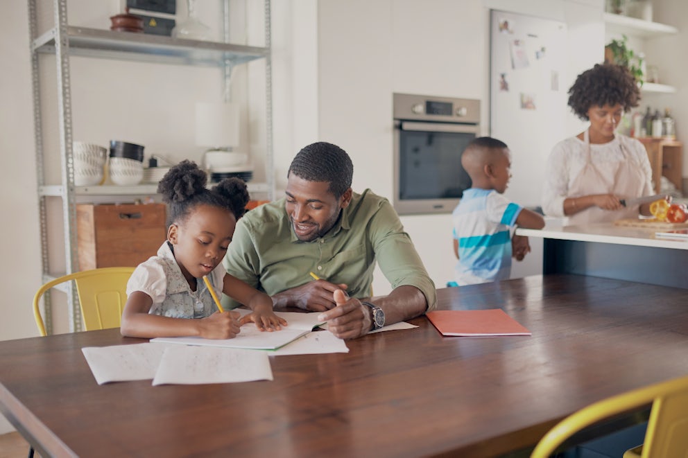 father helping daughter with homework