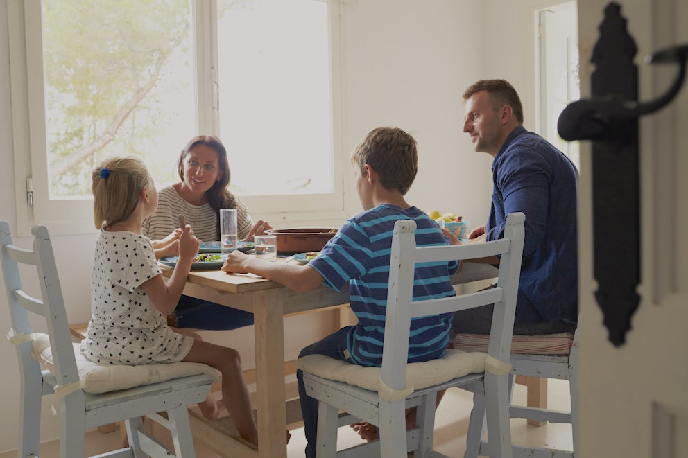 family talking at the table over dinner