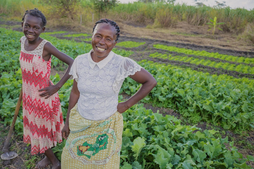 mother and daughter standing in a field to show off their crop