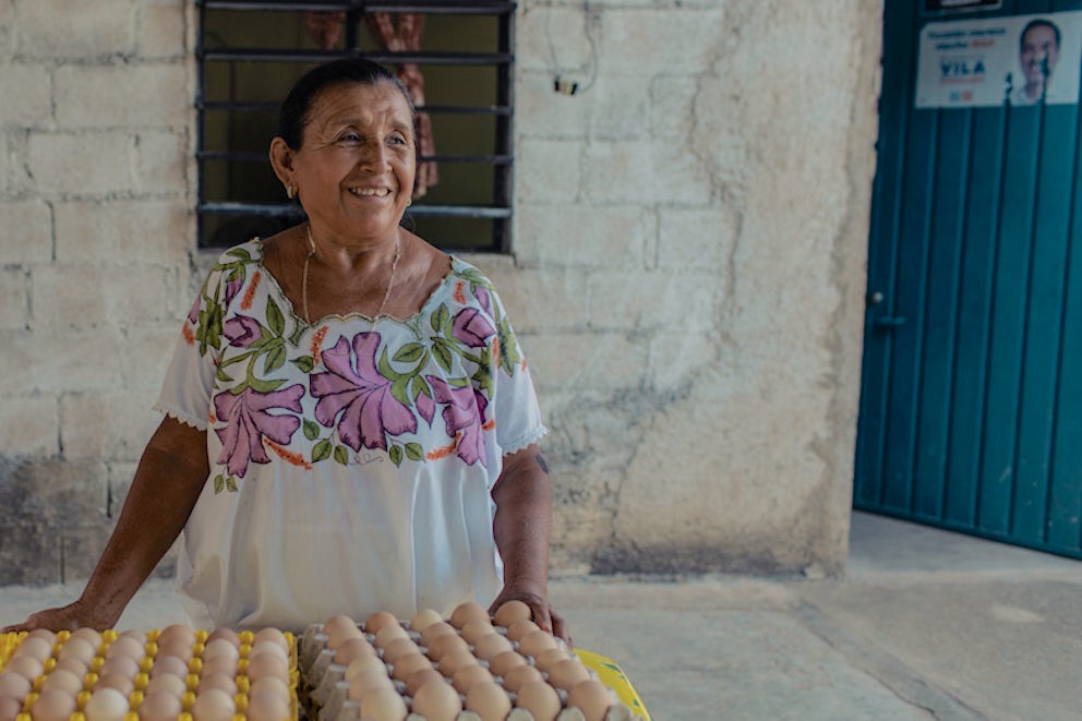 businesswoman posing with eggs her chickens produced