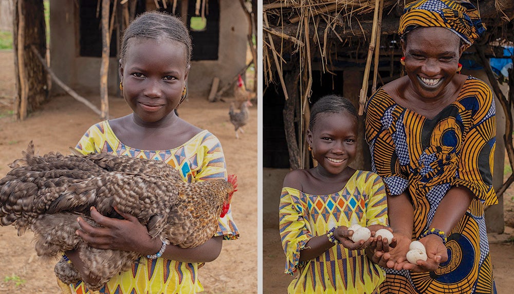 Khardiata holds her family's new chicken they received from Heifer.
