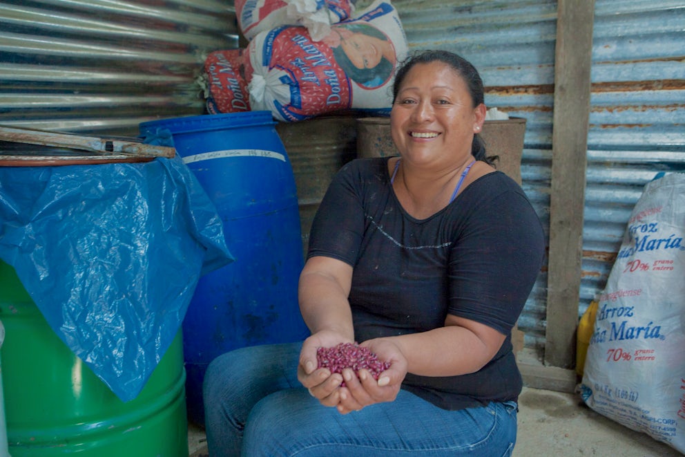 Santos holds seeds in her hand.