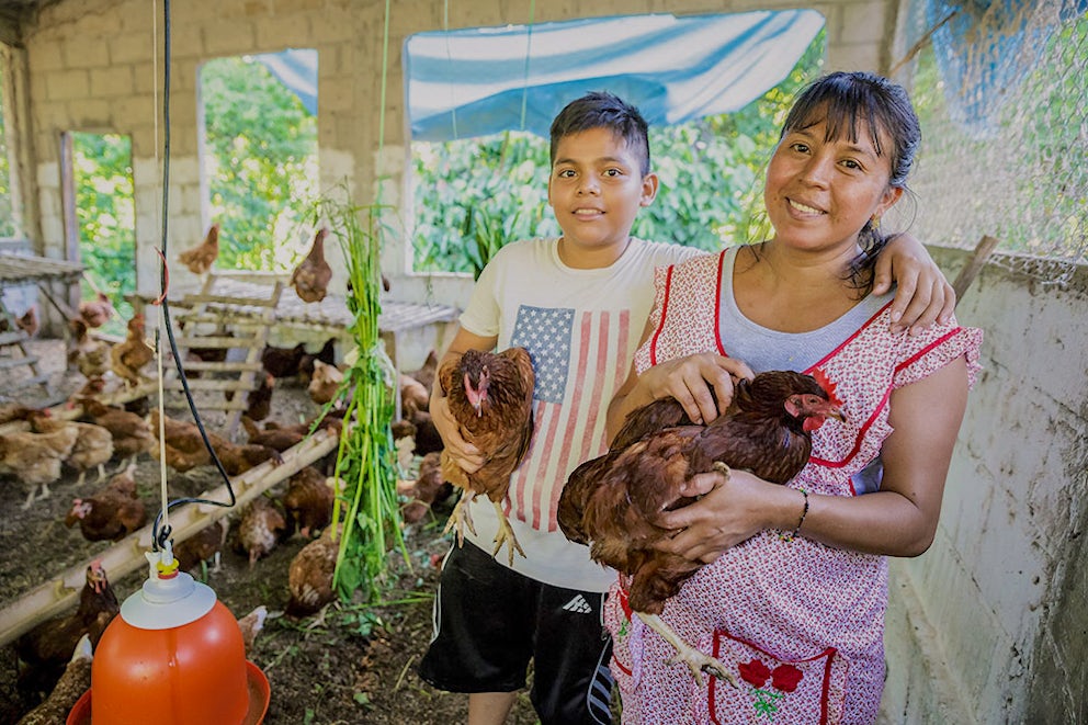 Georgina and son holding chickens