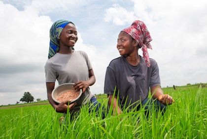 Felicia Gbuuka (right) and her daughter work on their rice field in Nigeria