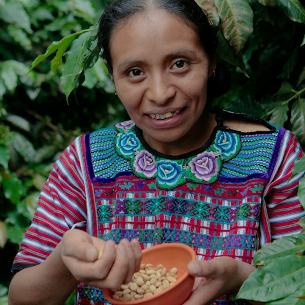 Woman holds coffee beans