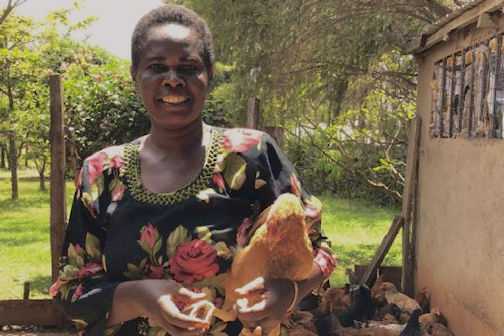 Woman holding a chicken