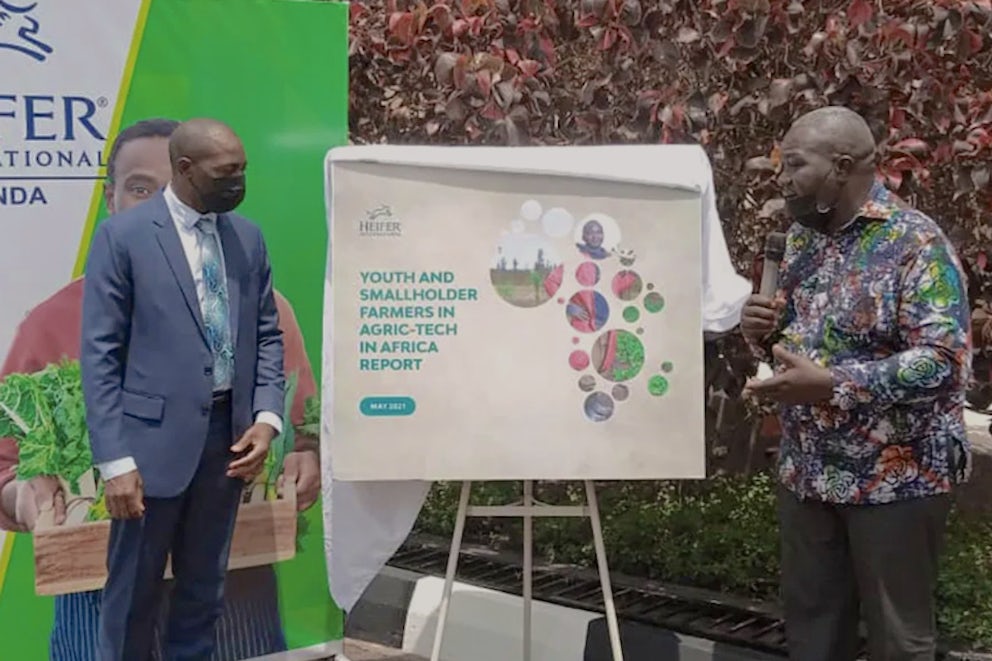 two men presenting Heifer's study on stage
