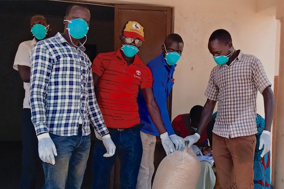 Cover of Uganda Report featuring men wearing masks