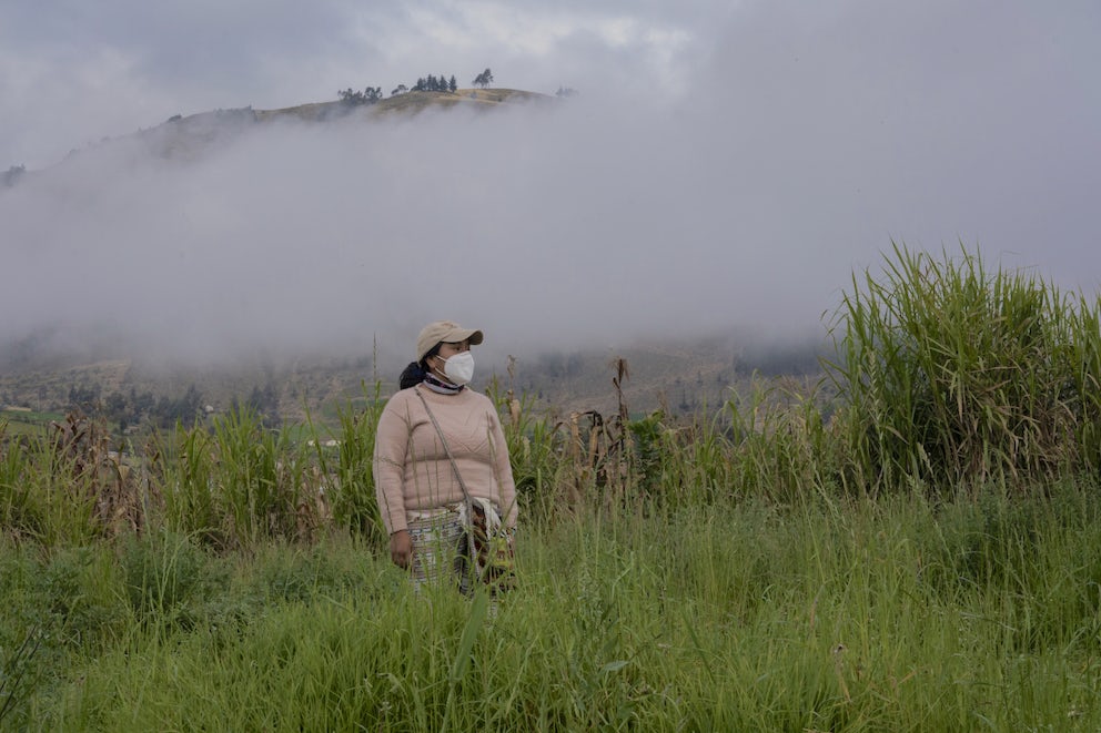 Woman in a hilltop field in Ecuador