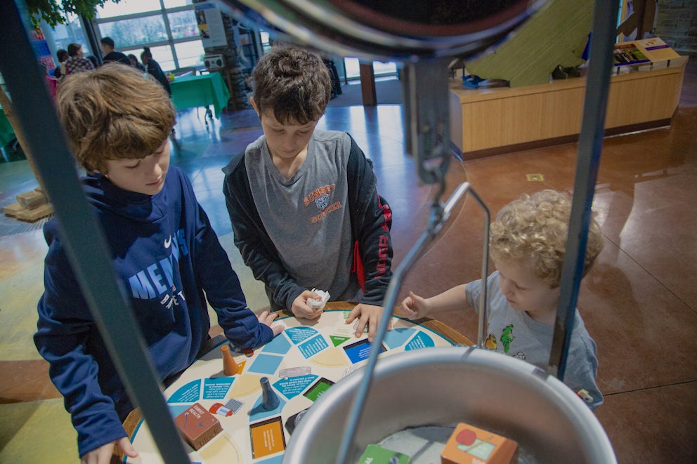 Children at an interactive exhibit at Heifer Village.