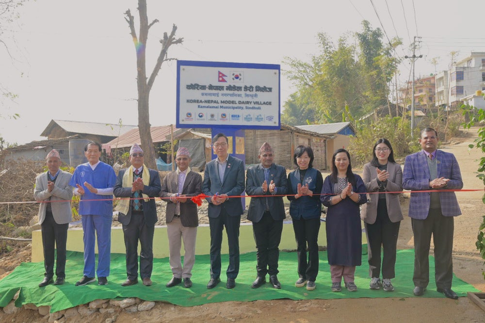 A group of individuals participate in a ribbon-cutting ceremony.
