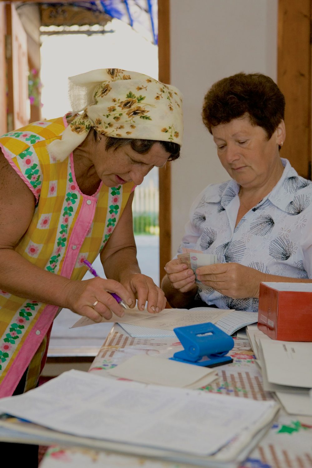 Two women exchange money.