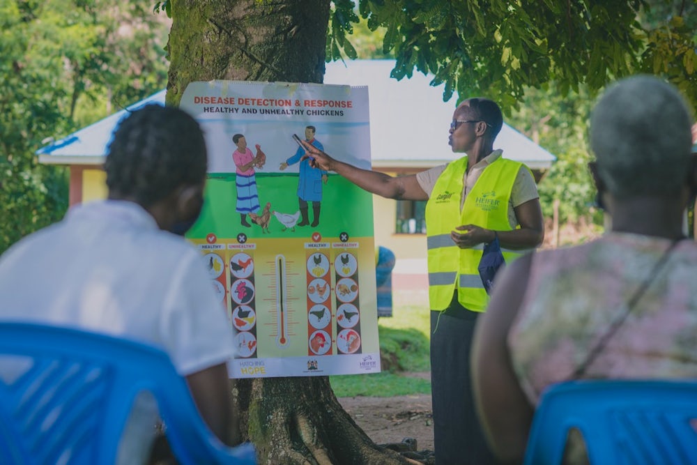 A woman conducts a training for farmers in Kenya.