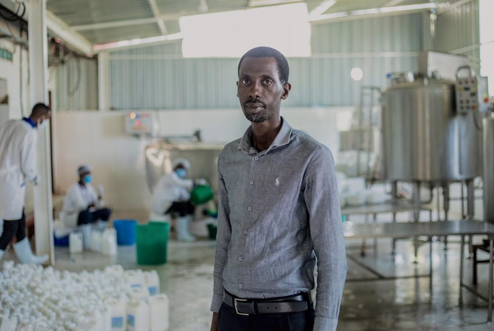 A man stands in a milk processing facility in Rwanda.