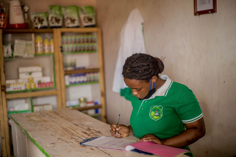 A girl conducts bookkeeping at her job in Rwanda.