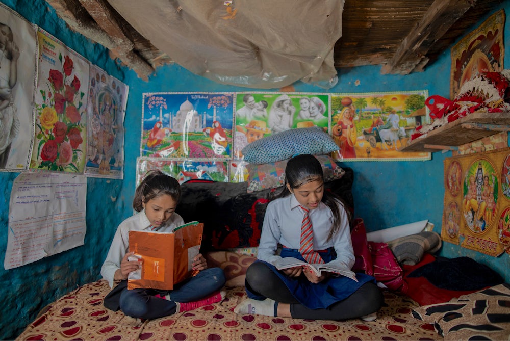 Bishnu's daughters study at home.