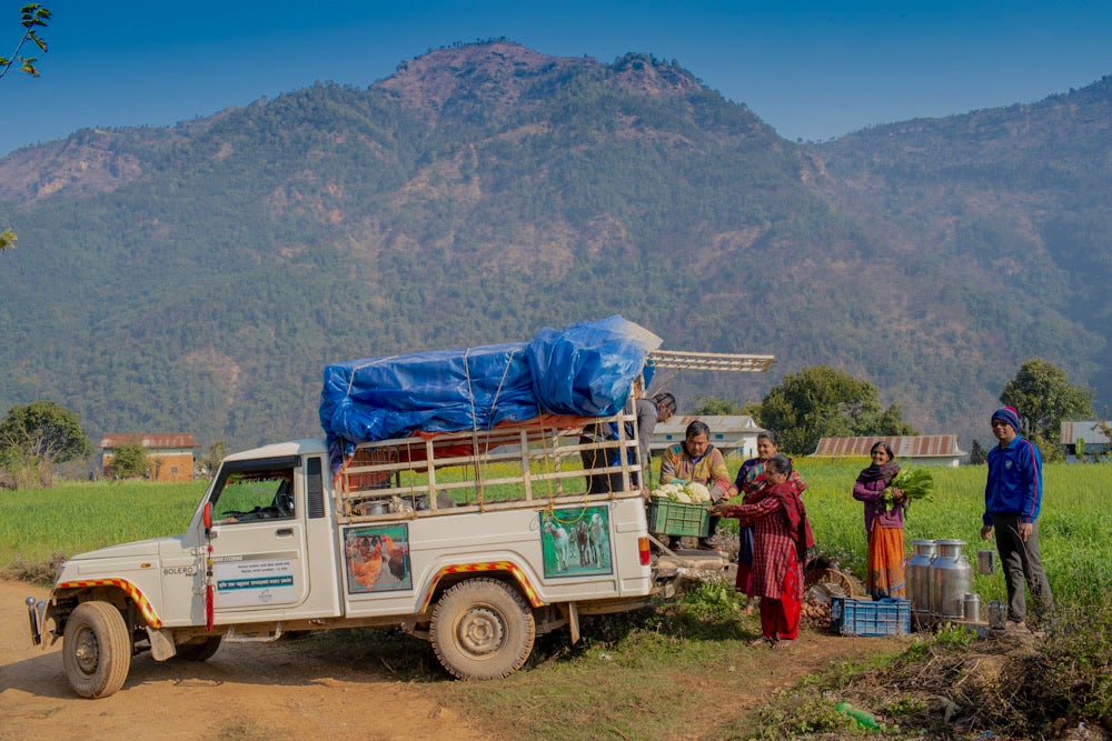 Farmers load produce into a truck in Nepal.