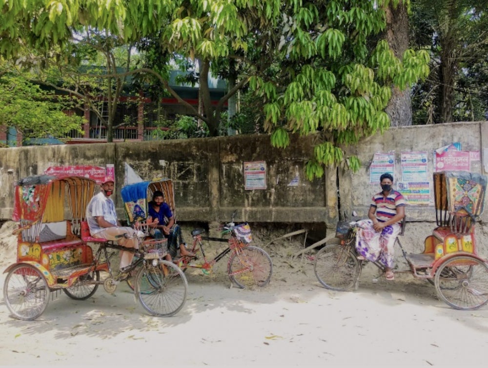 Rickshaw pullers wearing masks to protect themselves from COVID-19 virus.