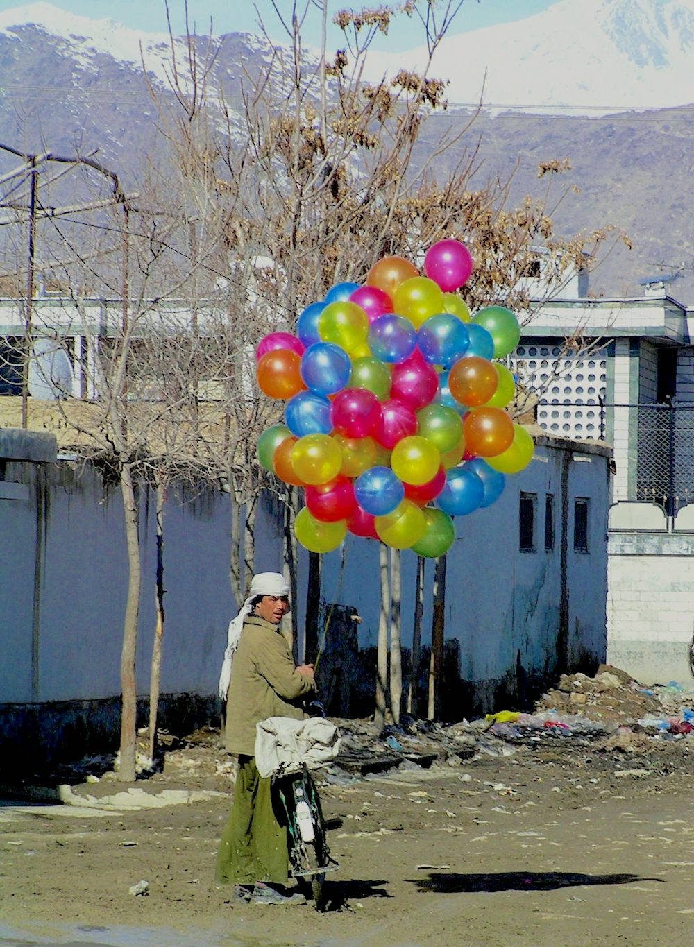 This man in Kabul travels through the neighborhoods of the city on his bicycle selling balloons to children.  