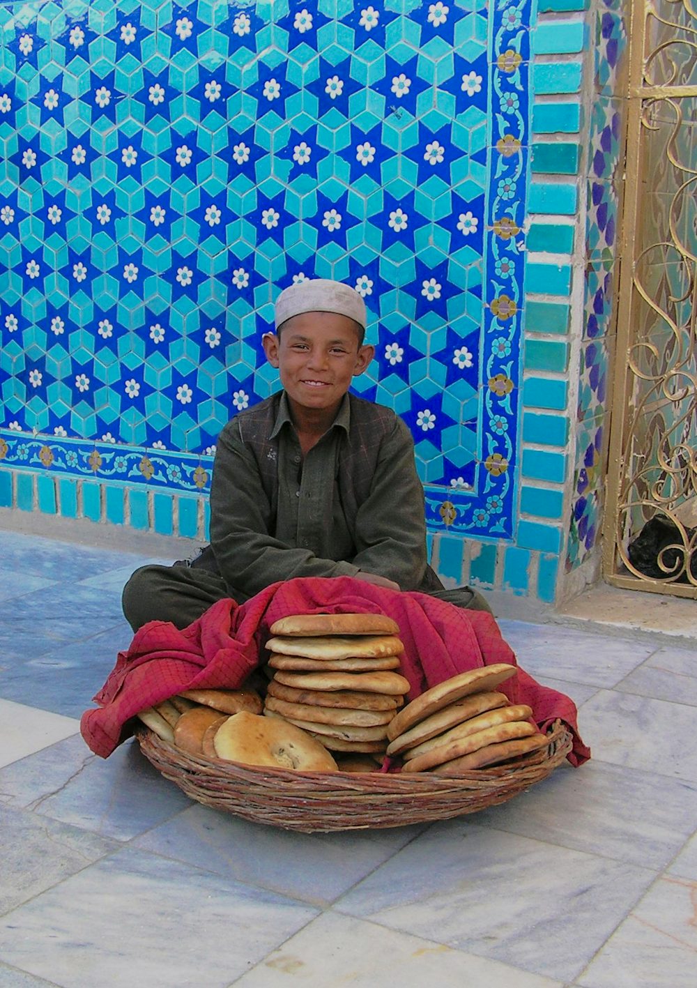 Young boy selling bread at the Blue Mosque in Mazar e Sharif. This round Afghan naan bread is typical of the northern part of the country. In Kabu, the bread is an elongated oval (caption and photos by David Sherman).
