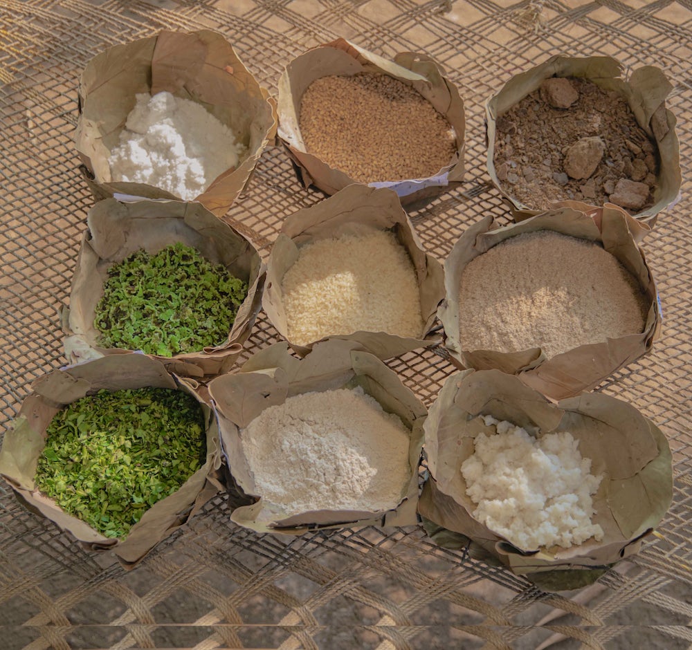 Nine components of a nutritious chicken feed sit in bowls.