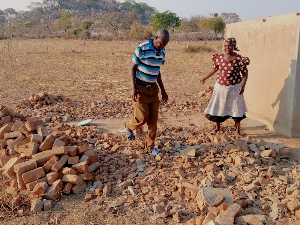 Cyclone survivors salvage building materials.