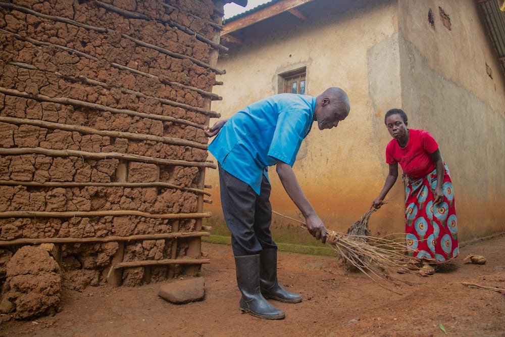Sibomana helps his wife Beatha with household chores. There was a time when he didn't help out around the house.