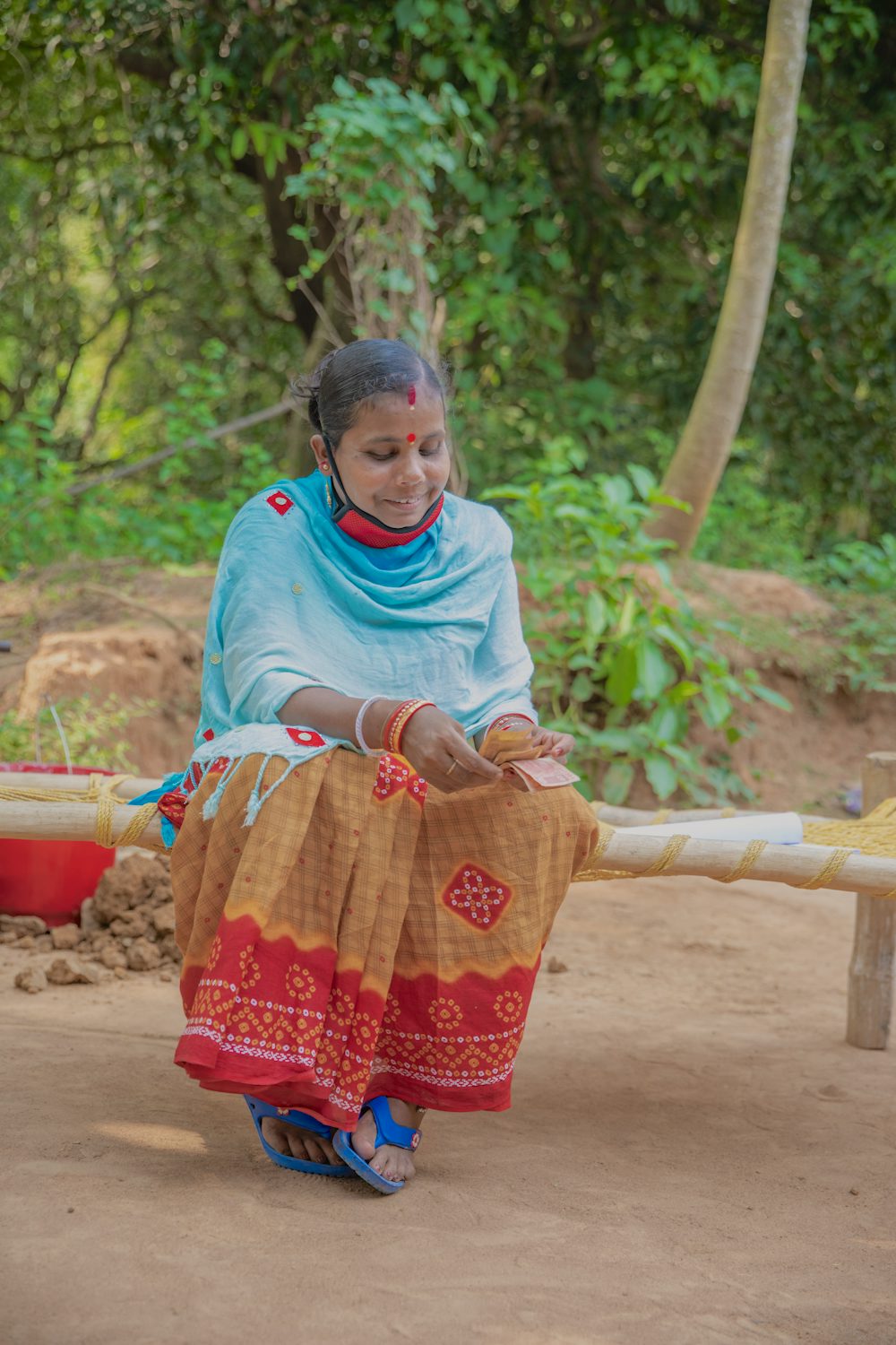 Geeta Rani Jena counts her earnings from a day's work.