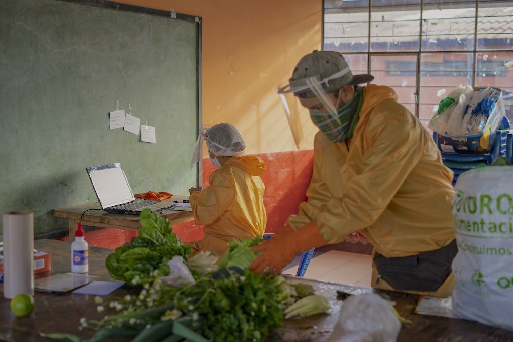 Two workers in prepare food packages in one of the collection centers in Quito, Ecuador.