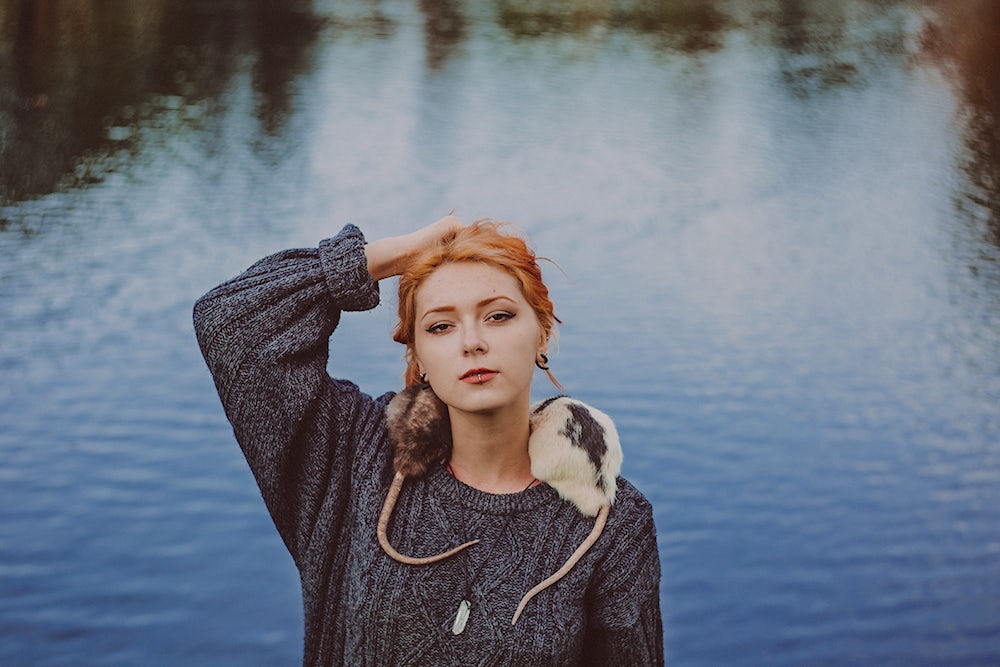 A woman with two rats on her shoulders