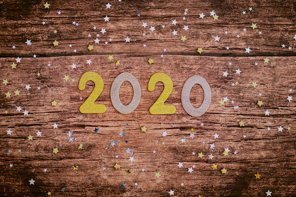 Gold Paper numbers lay on a dark wooden surface