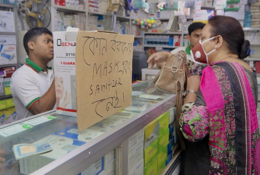 People in India stock up on hand sanitizer and masks to prepare for COVID-19.