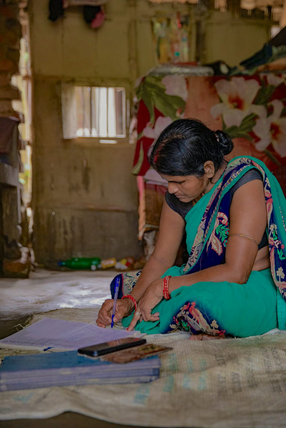 A women writing in her notebook.