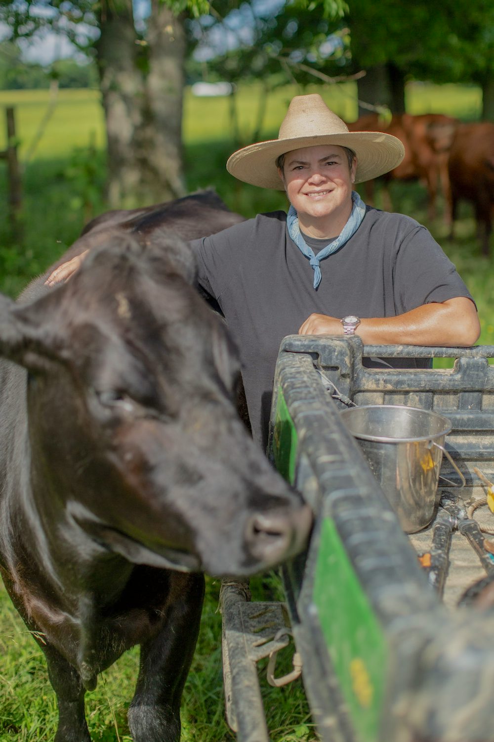 Donna Kilpatrick stands with a large, black cow.