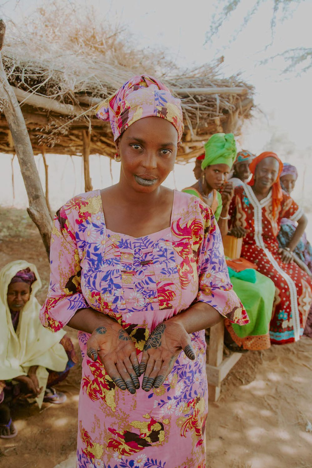 Fatimata Ba and many of the other women who tend the water pump and gardens in Younoufere wear intricate tattoos on their hands and feet. Photo by Lacey West.