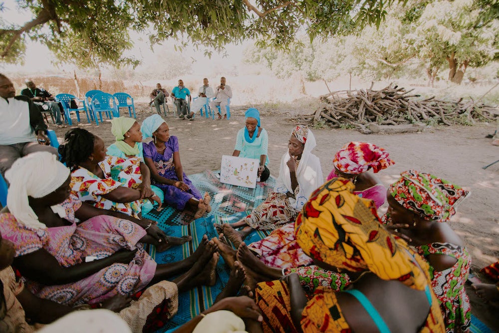 Banna Mballo leads group members in the week’s lesson about nutrition. Photo by Lacey West.