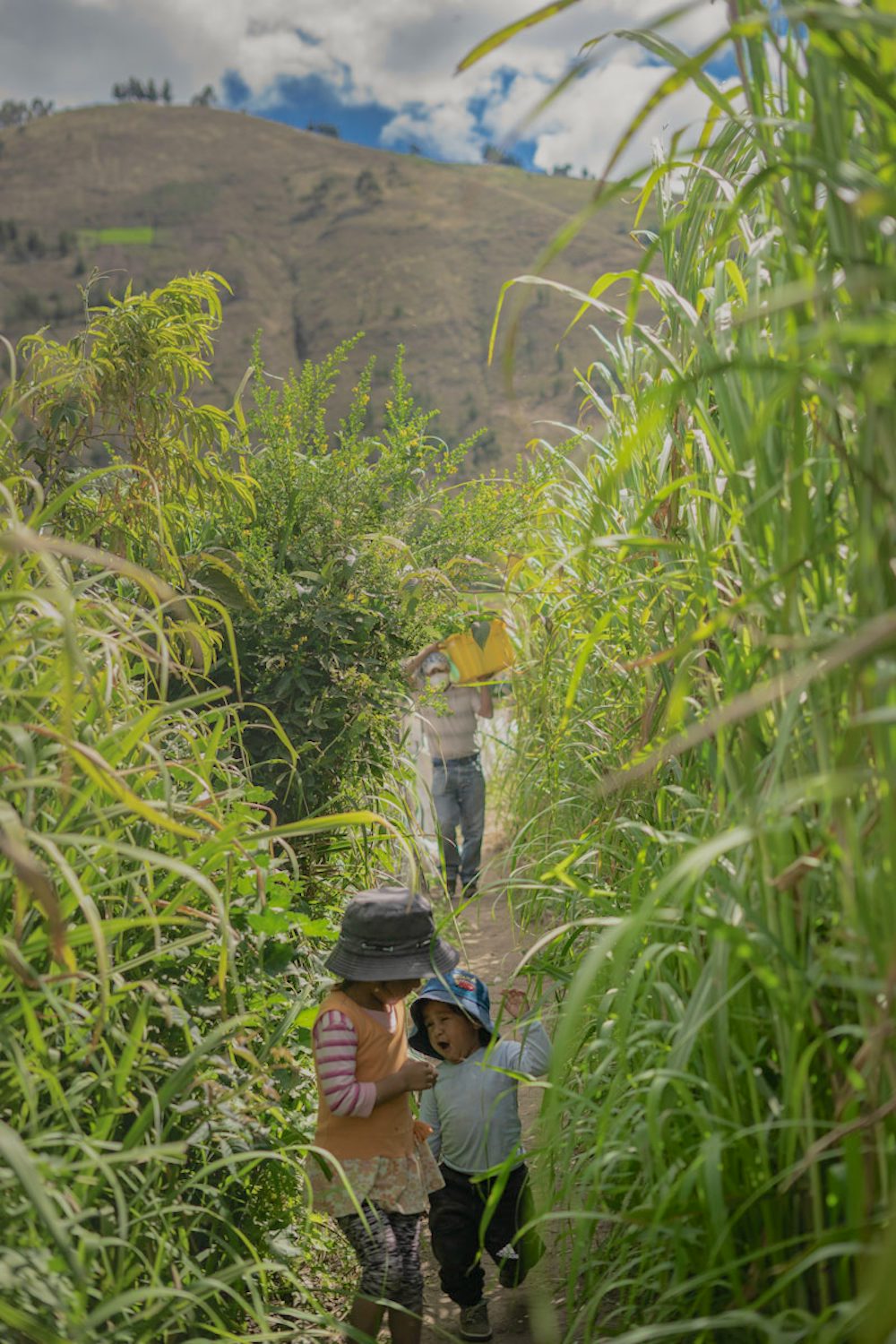 A farmer and children on a farm in Ecuador.