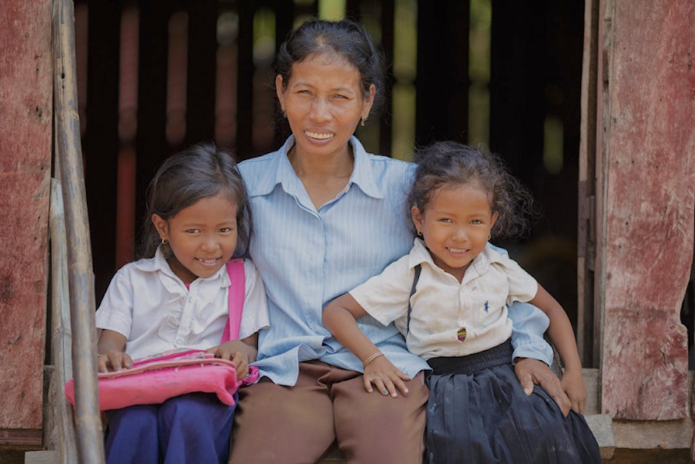 Dos Sok, 45, with her nieces Soriya Nang, 4 (right), her sister Nang Seima, 6, in their school uniforms.