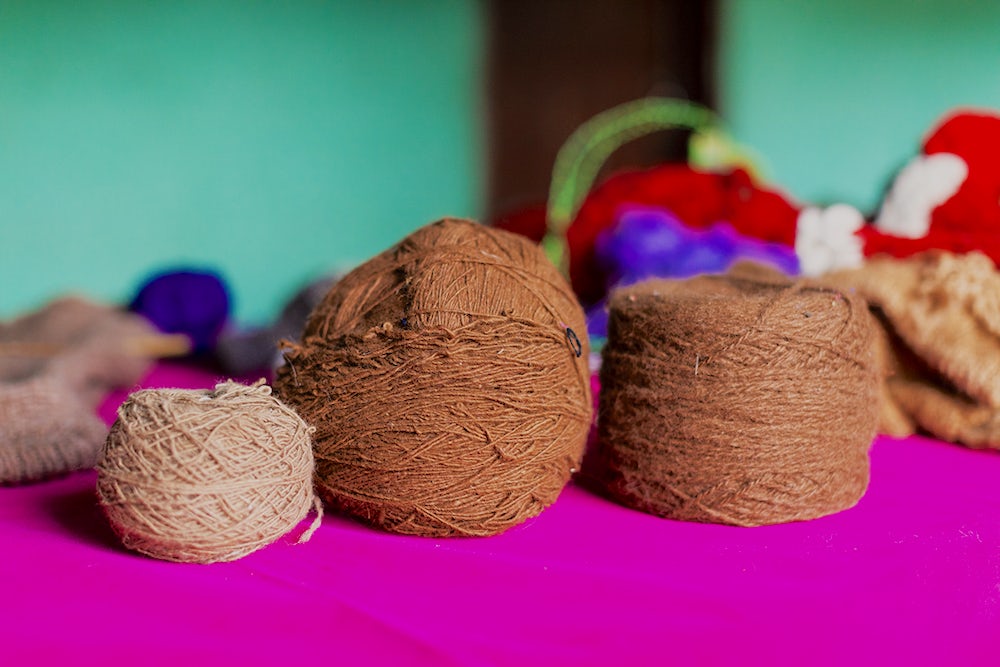 Alpaca yarn hand-spun by Heifer project participants, in varying natural colors and thickness.