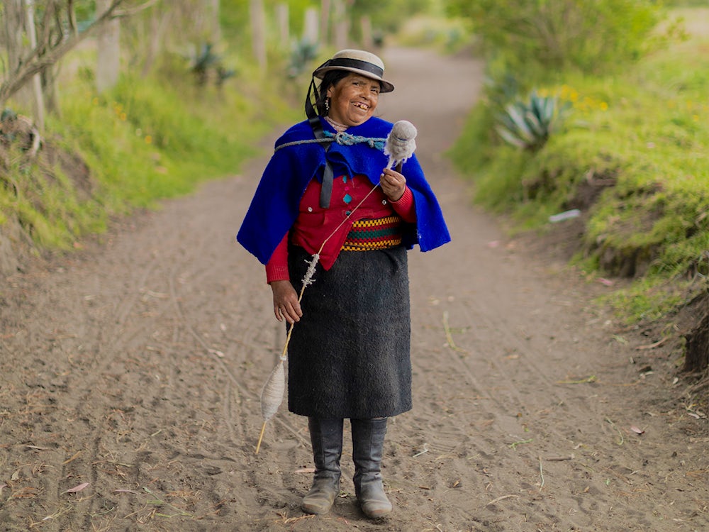 Maria Micaela Castro Sisa, 48, spins wool as she walks down a path in a village near Riobamba, Ecuador. 