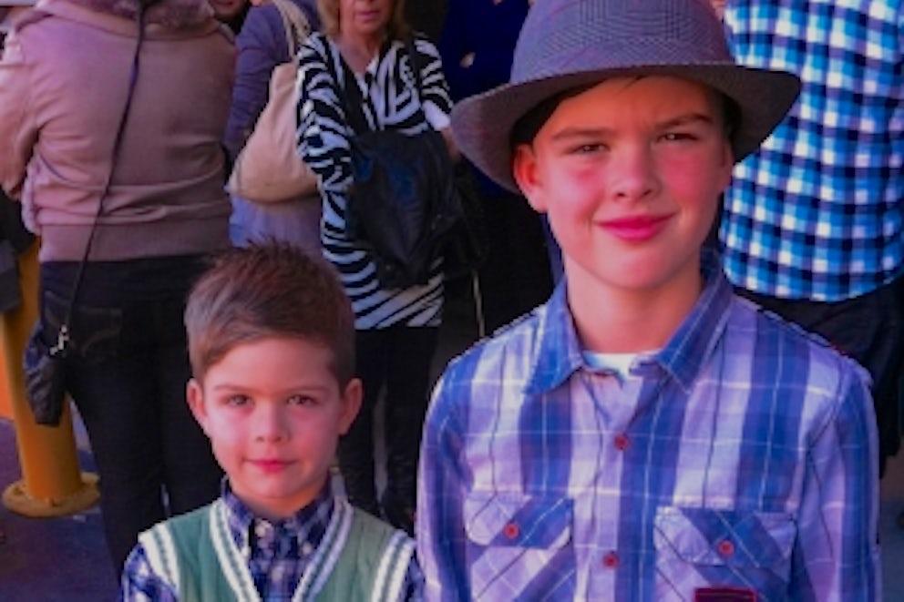 Two young fundraisers smile at the camera.