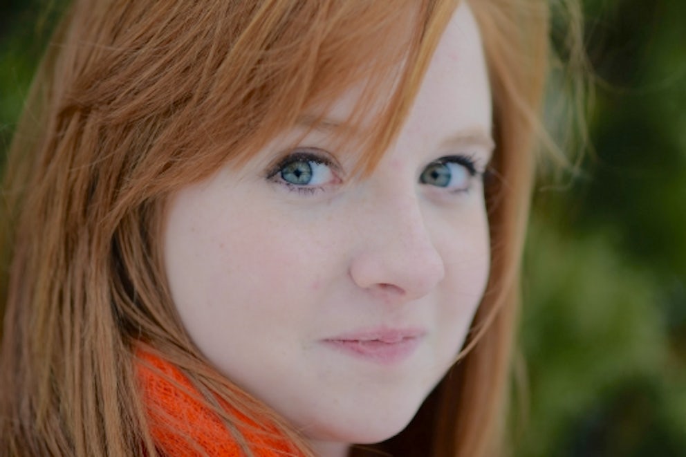 A young lady smiles at the camera.